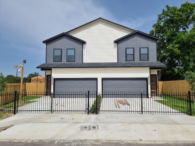 4539 Rosemont St A/B, Unit A/B Houston, TX 77051 - view of front of house with a garage, driveway, a fenced front yard, and stucco siding