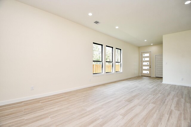 90 Burress St Unit A, Houston, TX 77022 - spare room featuring recessed lighting, light wood-style floors, and baseboards