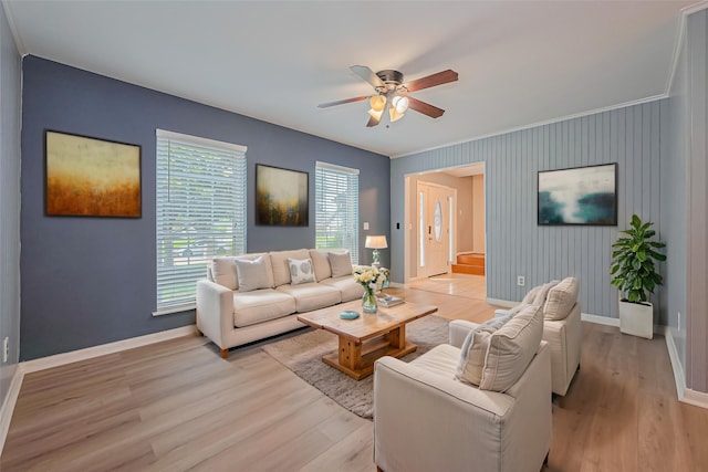 1010 Cheyenne Meadows Dr, Katy, TX 77450 - living area featuring baseboards, light wood-style floors, a ceiling fan, an accent wall, and ornamental molding