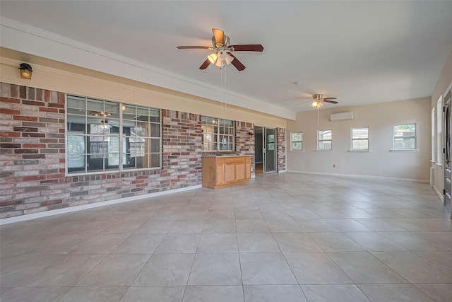 1010 Cheyenne Meadows Dr, Katy, TX 77450 - unfurnished living room featuring a wall mounted AC, ceiling fan, brick wall, baseboards, and light tile patterned floors