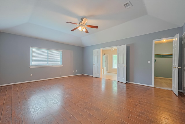 1010 Cheyenne Meadows Dr, Katy, TX 77450 - unfurnished bedroom featuring a raised ceiling, multiple windows, wood finished floors, and lofted ceiling