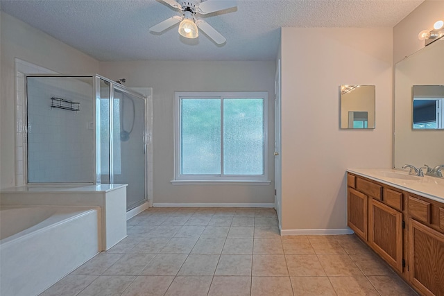 1010 Cheyenne Meadows Dr, Katy, TX 77450 - bathroom with vanity, a stall shower, a textured ceiling, a bath, and tile patterned flooring