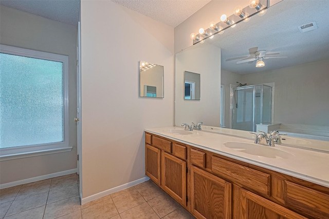 1010 Cheyenne Meadows Dr, Katy, TX 77450 - full bath featuring a stall shower, double vanity, tile patterned floors, a textured ceiling, and ceiling fan