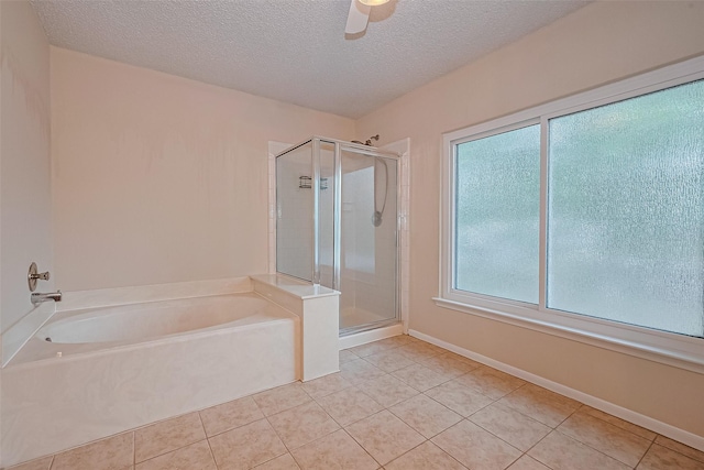 1010 Cheyenne Meadows Dr, Katy, TX 77450 - full bathroom featuring a bath, tile patterned flooring, a shower stall, a ceiling fan, and a textured ceiling