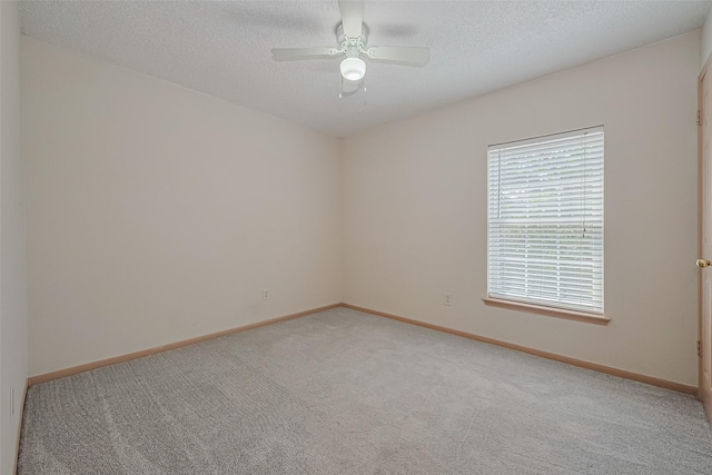 1010 Cheyenne Meadows Dr, Katy, TX 77450 - unfurnished room featuring light colored carpet, ceiling fan, baseboards, and a textured ceiling