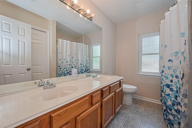 1010 Cheyenne Meadows Dr, Katy, TX 77450 - full bath featuring double vanity, toilet, baseboards, a textured ceiling, and a shower with shower curtain
