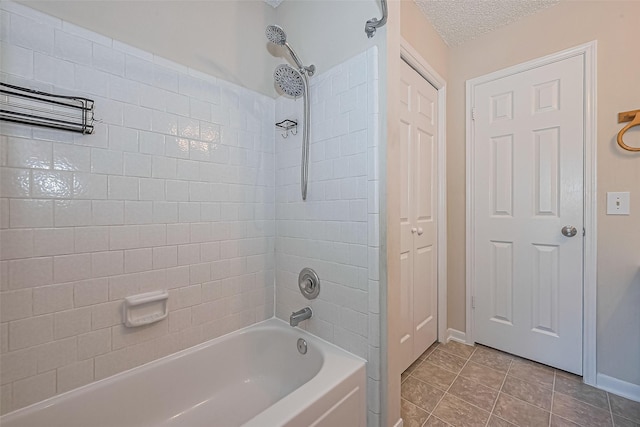 1010 Cheyenne Meadows Dr, Katy, TX 77450 - bathroom featuring washtub / shower combination, baseboards, and a textured ceiling