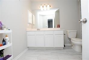 4619 Ehrlich Ct, Rosenberg, TX 77471 - bathroom with toilet, vanity, and baseboards