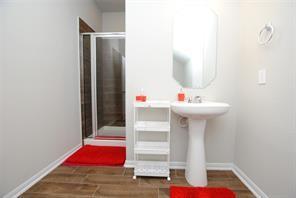4619 Ehrlich Ct, Rosenberg, TX 77471 - bathroom with a shower stall, wood finished floors, and baseboards