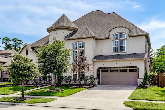 3650 Sage Hollow Dr, Spring, TX 77386 - french country home featuring stucco siding, driveway, a garage, and roof with shingles