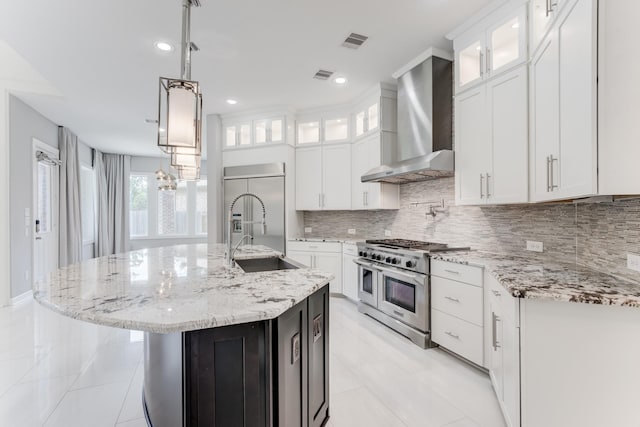 3650 Sage Hollow Dr, Spring, TX 77386 - kitchen featuring wall chimney exhaust hood, premium appliances, a sink, backsplash, and white cabinets