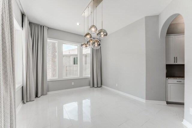 3650 Sage Hollow Dr, Spring, TX 77386 - unfurnished dining area featuring arched walkways, a chandelier, recessed lighting, baseboards, and light tile patterned floors
