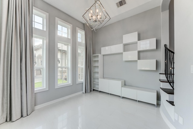 3650 Sage Hollow Dr, Spring, TX 77386 - unfurnished living room with a chandelier, stairs, baseboards, a high ceiling, and light tile patterned floors
