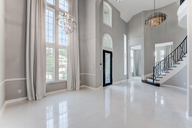 3650 Sage Hollow Dr, Spring, TX 77386 - tiled foyer with a chandelier, a towering ceiling, baseboards, and stairs