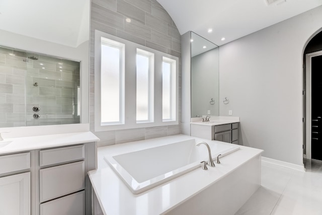3650 Sage Hollow Dr, Spring, TX 77386 - full bathroom with vanity, a garden tub, a tile shower, tile patterned floors, and lofted ceiling