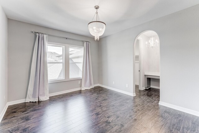 3650 Sage Hollow Dr, Spring, TX 77386 - spare room featuring a chandelier, arched walkways, wood finished floors, and baseboards