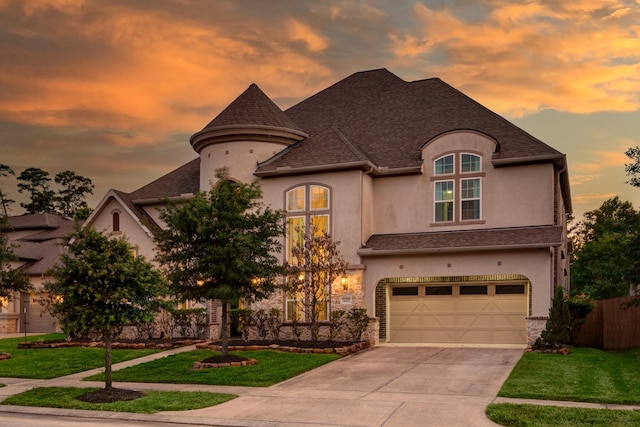 3650 Sage Hollow Dr, Spring, TX 77386 - french country style house featuring stucco siding, concrete driveway, a garage, and a shingled roof