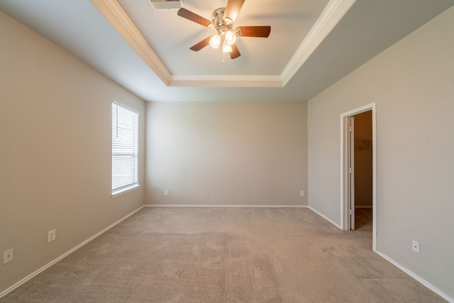 16414 Peyton Stone Cir, Houston, TX 77049 - spare room featuring a raised ceiling, light colored carpet, ornamental molding, ceiling fan, and baseboards