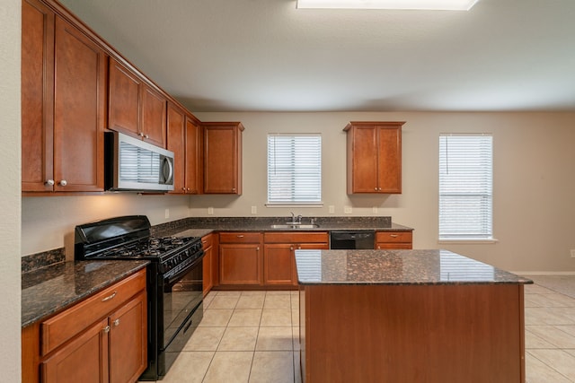 16414 Peyton Stone Cir, Houston, TX 77049 - kitchen with black appliances, a sink, light tile patterned floors, dark stone countertops, and a center island