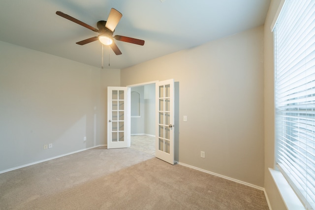 16414 Peyton Stone Cir, Houston, TX 77049 - empty room featuring french doors, a ceiling fan, carpet floors, and baseboards