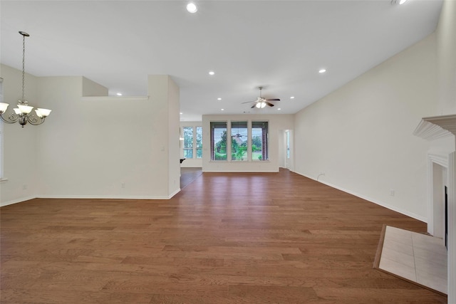 10938 Glenrothers Dr, Richmond, TX 77407 - unfurnished living room featuring ceiling fan, wood finished floors, a chandelier, and recessed lighting