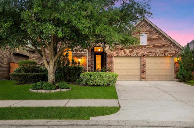 10938 Glenrothers Dr, Richmond, TX 77407 - view of front of home featuring brick siding, an attached garage, concrete driveway, and a front yard