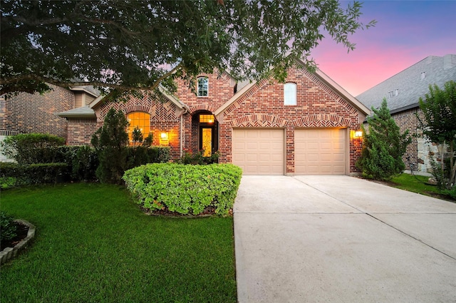 10938 Glenrothers Dr, Richmond, TX 77407 - view of front facade featuring brick siding, a garage, driveway, and a yard