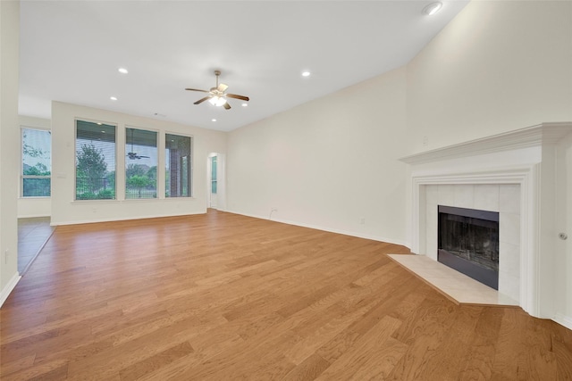 10938 Glenrothers Dr, Richmond, TX 77407 - unfurnished living room featuring ceiling fan, light wood-style flooring, a fireplace, and recessed lighting