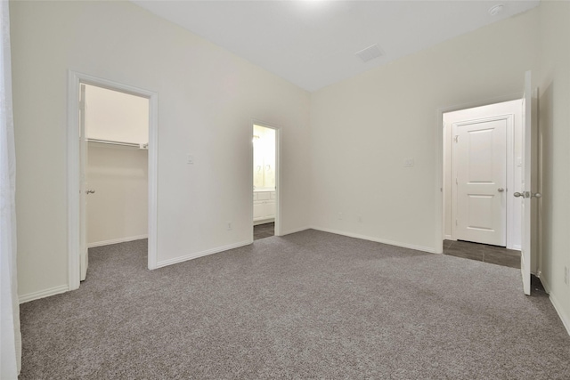10938 Glenrothers Dr, Richmond, TX 77407 - unfurnished bedroom featuring dark colored carpet, a spacious closet, a closet, and ensuite bathroom