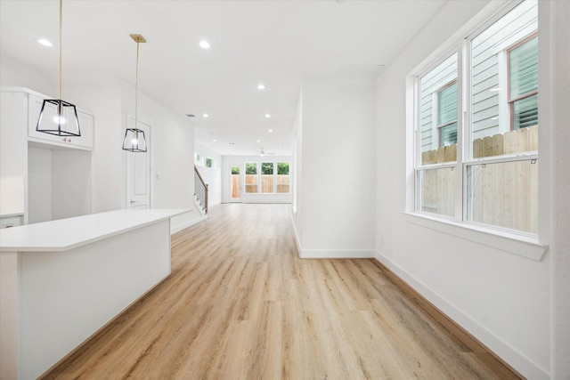 1212 Nadine St, Houston, TX 77009 - hallway featuring light wood-type flooring, recessed lighting, stairway, and baseboards