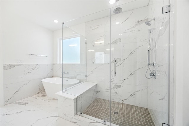 1212 Nadine St, Houston, TX 77009 - bathroom featuring a freestanding bath, a marble finish shower, marble tiled floors, tile walls, and wainscoting