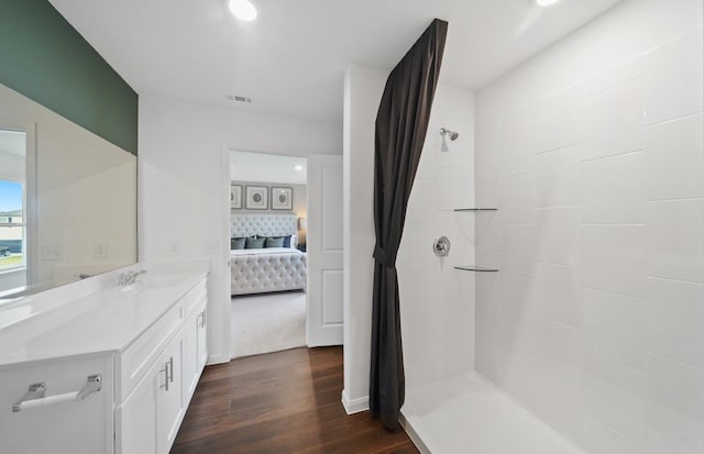 25319 Merino Dr, Magnolia, TX 77355 - full bathroom with ensuite bath, wood finished floors, vanity, a tile shower, and tasteful backsplash
