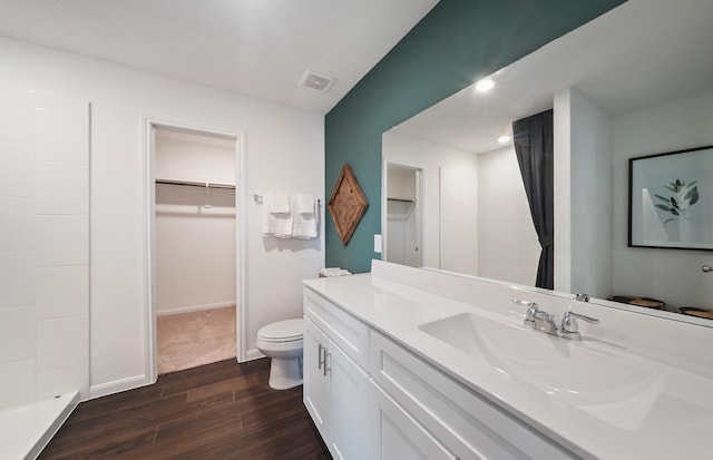 25319 Merino Dr, Magnolia, TX 77355 - bathroom with wood finished floors, toilet, vanity, a walk in closet, and a shower
