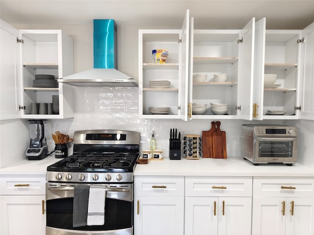 11810 Sagedowne Ln, Houston, TX 77089 - kitchen featuring open shelves, stainless steel gas range oven, wall chimney range hood, and white cabinets