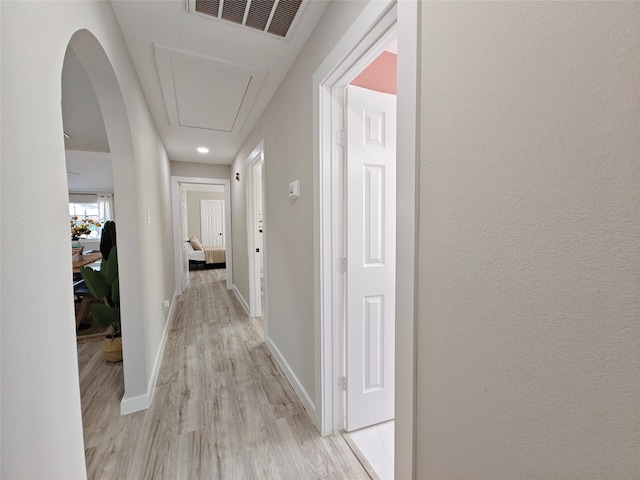 11810 Sagedowne Ln, Houston, TX 77089 - hall with attic access, light wood-style flooring, baseboards, and arched walkways