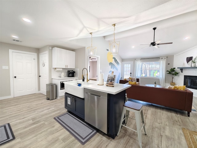 11810 Sagedowne Ln, Houston, TX 77089 - kitchen featuring dishwasher, a sink, open floor plan, lofted ceiling, and light countertops