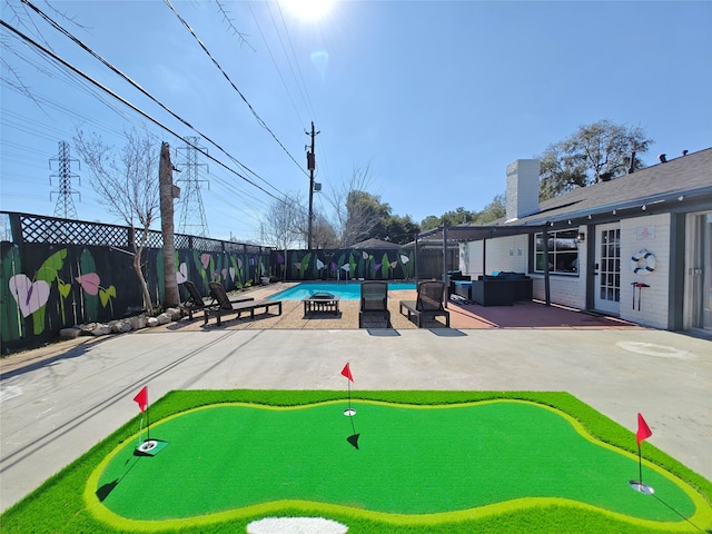 11810 Sagedowne Ln, Houston, TX 77089 - view of community with a putting green, a patio area, a swimming pool, and a fenced backyard