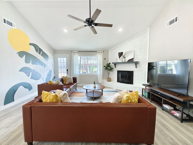 11810 Sagedowne Ln, Houston, TX 77089 - living area with lofted ceiling, wood finished floors, a ceiling fan, a brick fireplace, and baseboards