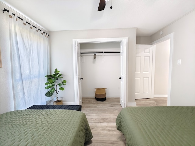 11810 Sagedowne Ln, Houston, TX 77089 - bedroom with light wood-type flooring, baseboards, ceiling fan, and a closet