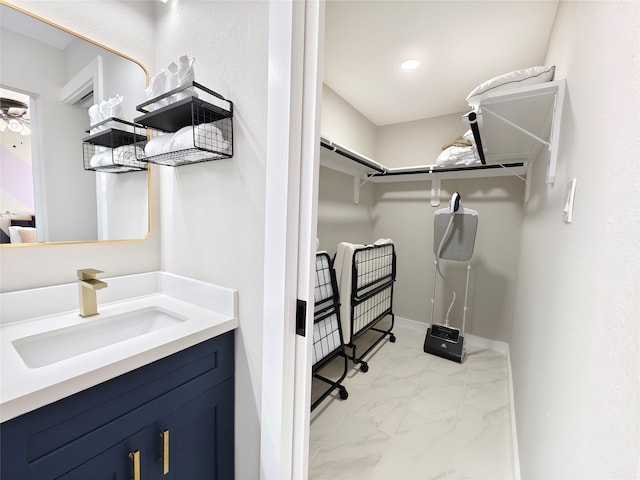 11810 Sagedowne Ln, Houston, TX 77089 - walk in closet with light marble finish floors and a sink