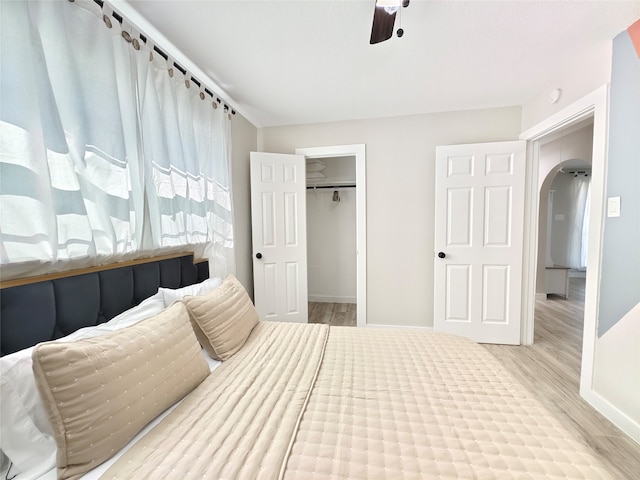 11810 Sagedowne Ln, Houston, TX 77089 - bedroom featuring wood finished floors, baseboards, arched walkways, and ceiling fan