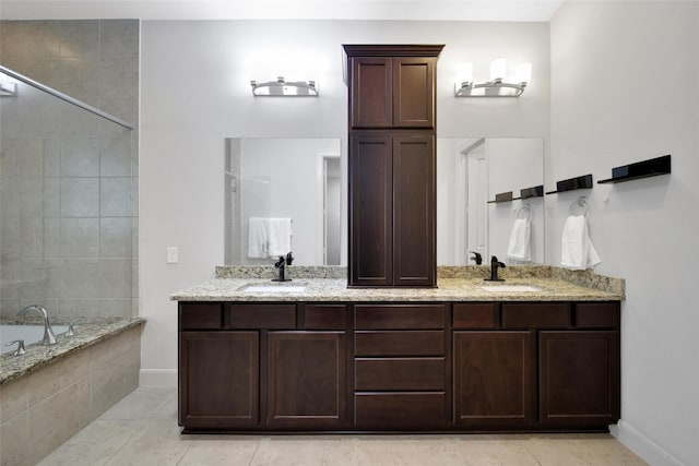 118 Grant Cove Dr, Montgomery, TX 77316 - full bath with baseboards, double vanity, tiled bath, tile patterned floors, and a tile shower
