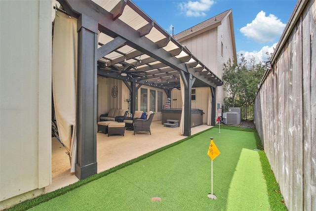 118 Grant Cove Dr, Montgomery, TX 77316 - view of patio / terrace with a putting green, a pergola, a hot tub, central AC unit, and an outdoor living space