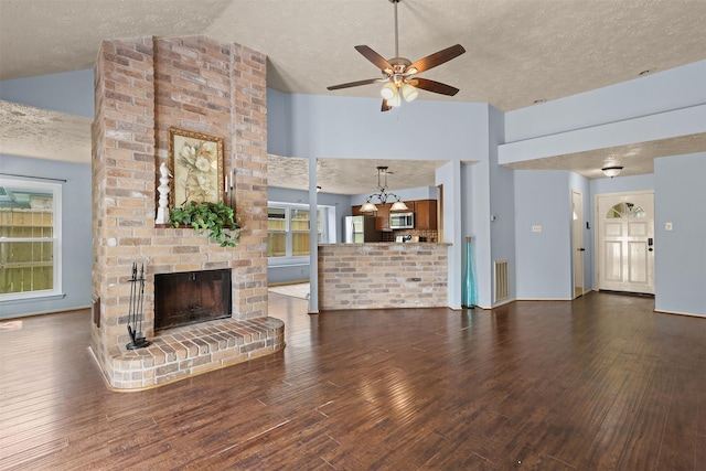 414 Enfield Dr, Highlands, TX 77562 - unfurnished living room featuring a textured ceiling, wood finished floors, a ceiling fan, a fireplace, and baseboards