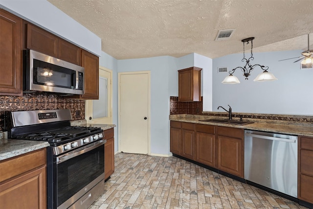 414 Enfield Dr, Highlands, TX 77562 - kitchen featuring stainless steel appliances, a sink, decorative backsplash, a ceiling fan, and decorative light fixtures