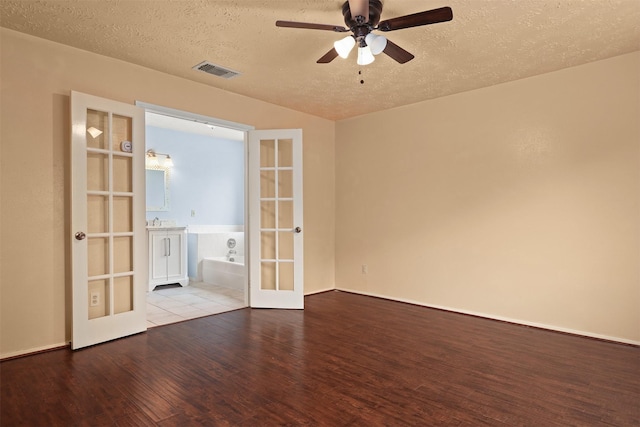 414 Enfield Dr, Highlands, TX 77562 - spare room with french doors, wood finished floors, a textured ceiling, a ceiling fan, and baseboards