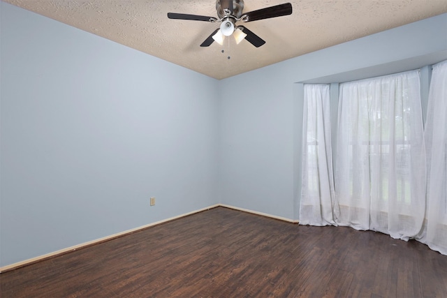 414 Enfield Dr, Highlands, TX 77562 - spare room featuring dark wood-style floors, a ceiling fan, baseboards, and a textured ceiling