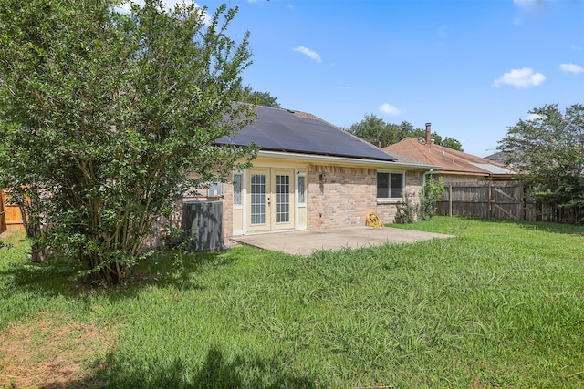414 Enfield Dr, Highlands, TX 77562 - rear view of house with french doors, a patio, solar panels, and brick siding