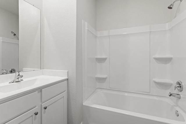 7606 Thrips Ln, Richmond, TX 77469 - bathroom with bathing tub / shower combination, vanity, and a textured wall