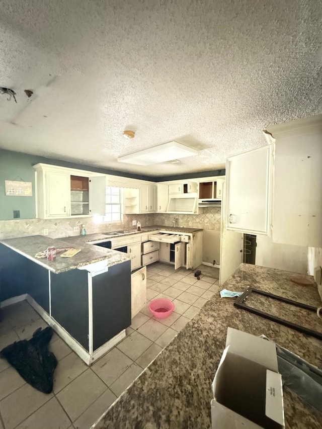 15125 S Dr, Channelview, TX 77530 - kitchen with a textured ceiling, a peninsula, open shelves, white cabinetry, and light tile patterned flooring